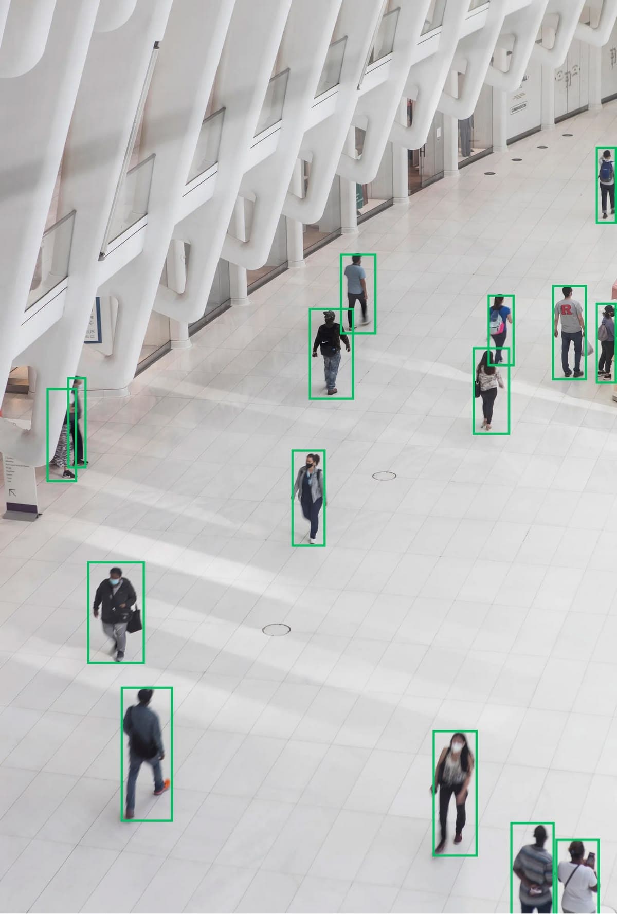 Video analytics: boxes identifying each pedestrian in a large lobby seen from above